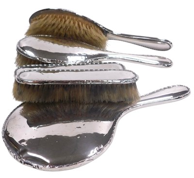 Lot 386 - A George V silver backed five piece dressing...