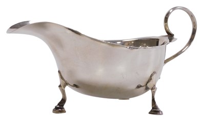 Lot 403 - A George V silver sauce boat, with scroll...