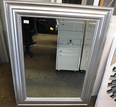Lot 1176 - A wall mirror, with a rectangular bevelled...
