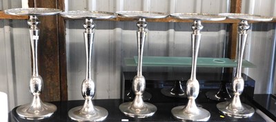 Lot 1182 - A set of five metal side tables, each with a...