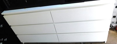 Lot 1187 - A white melamine six drawer chest, 77cm high,...