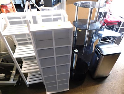 Lot 1201 - A black glass four tier display stand,...
