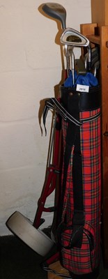 Lot 2018 - A golf bag and caddy, containing various golf...