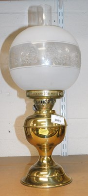 Lot 2073 - A brass oil lamp, with a frosted and clear...