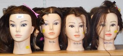 Lot 2087 - Nine hair styling mannequin heads, 28cm high.
