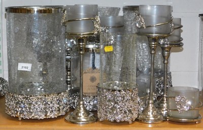 Lot 2102 - A quantity of metal and glass candle holders,...