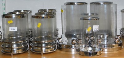 Lot 2104 - A quantity of metal and glass candle holders,...