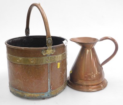 Lot 2220 - A copper and brass bound bucket, with swing...