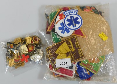 Lot 2254 - A quantity of enamel pin badges, together with...