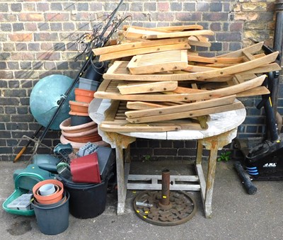 Lot 1217 - A teak slatted top garden table, together with...