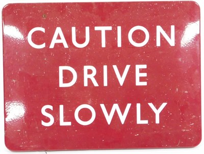 Lot 534 - A vintage Caution Drive Slowly red enamel sign,...