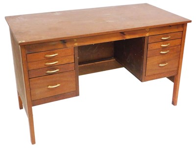 Lot 583 - A mid century teak kneehole desk, with an...