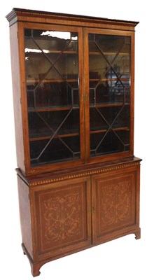 Lot 596 - An Edwardian mahogany cupboard bookcase, with...