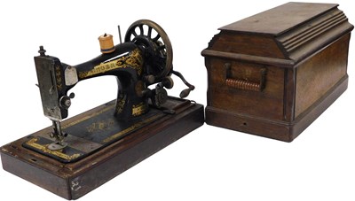 Lot 551 - A vintage sewing machine, oak cased, locked.