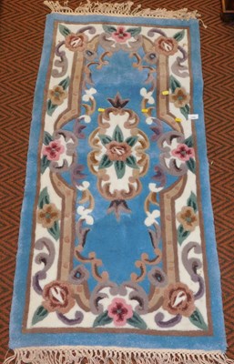 Lot 1222 - A Chinese floral blue ground rug.