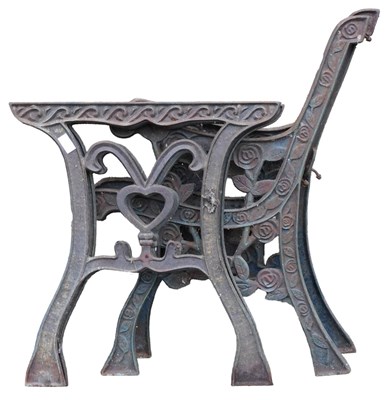 Lot 729 - A pair of cast iron bench ends and a central...