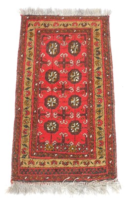 Lot 758 - A Bokhara red ground prayer rug, the central...