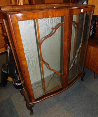 Lot 1031 - A walnut veneered display cabinet.