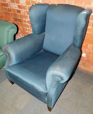 Lot 1011 - A wingback armchair, upholstered in teal...