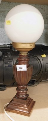 Lot 2024 - A carved wooden table lamp, with opaque...