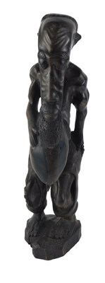 Lot 124 - Tribal Art. A carved wooden figure of man with...