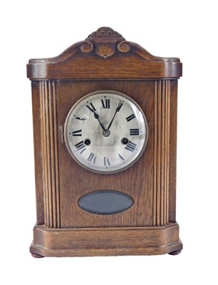 Lot 128 - A 20thC German style oak cased chiming mantel...
