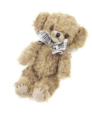 Lot 457 - A Merrythought tan teddy bear, with tartan bow,...