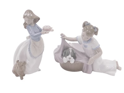 Lot 490 - Two Nao figures, comprising girl with puppy...