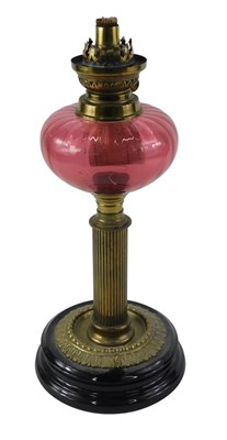 Lot 115 - A Victorian cranberry glass oil lamp, with...