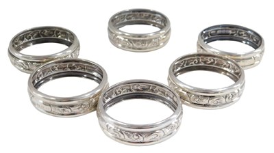Lot 667 - A set of six silver napkin rings, numbered 1-6,...
