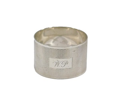 Lot 695 - An Elizabeth II silver napkin ring, engine...