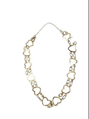 Lot 85 - A heart shaped charm bracelet, yellow metal...