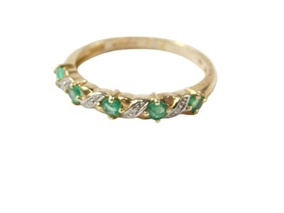 Lot 94 - A 9ct gold emerald and diamond half hoop dress...