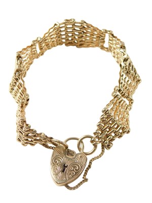 Lot 32 - A 9ct gold gate bracelet, of fan design, with...