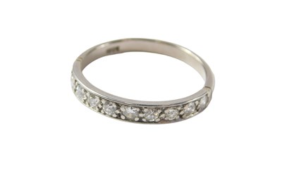 Lot 39 - A half hoop eternity ring, set with ten round...
