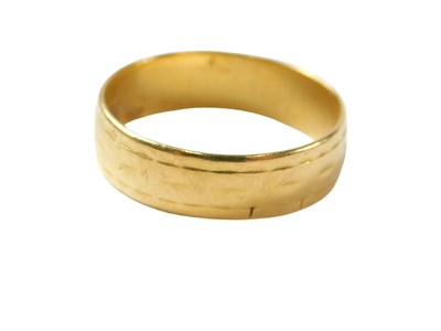 Lot 42 - A 22ct gold wedding band, of patterned design,...