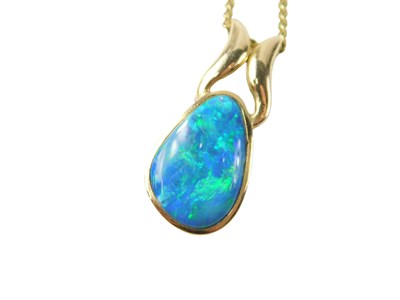 Lot 515 - A fire opal pendant and chain, the opal...