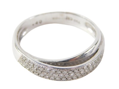 Lot 518 - An 18ct white gold diamond crossover ring,...