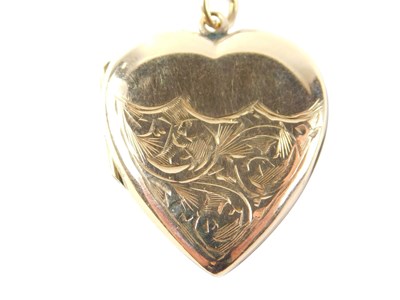 Lot 522 - A heart shaped locket pendant and chain, the...