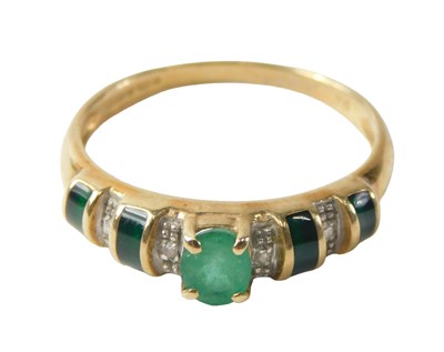 Lot 717 - A 9ct gold emerald and diamond half hoop dress...