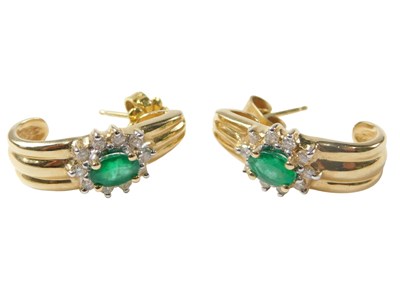 Lot 545 - A pair of emerald and diamond hoop...