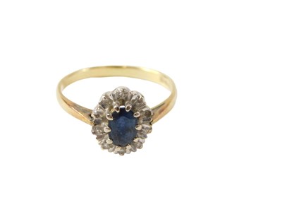Lot 544 - An 18ct gold cluster ring, with oval sapphire,...