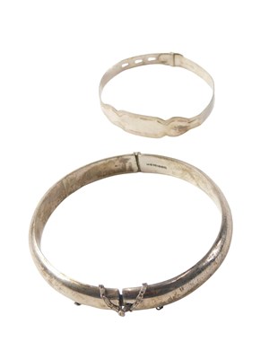 Lot 526 - Two silver bangles, comprising a half hinged...