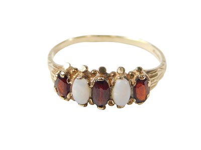Lot 76 - A 9ct gold dress ring, set with two opals and...