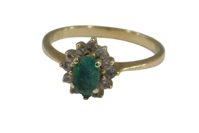 Lot 757 - An emerald and diamond cluster ring, with pale...
