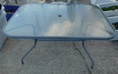 Lot 1640 - A glass topped rectangular garden table.