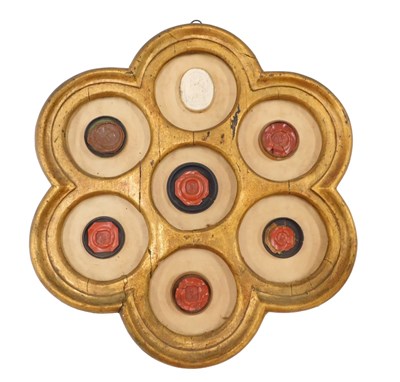 Lot 772 - A gilt gesso lobed frame, containing six wax...