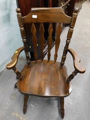 Lot 1578 - A dark stained oak fireside chair, with arms,...