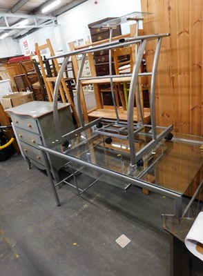 Lot 1547 - A metal and glass desk, with retractable...