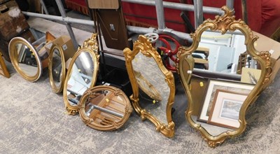 Lot 1590 - Six mirrors, of varying shapes, with gilt frames.